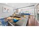 Open-concept living room boasts hardwood floors, modern decor, and seamless transition to a stylish kitchen at 10007 Hazelnut Ct, Tampa, FL 33647