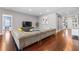 Bright, open living room with hardwood floors, a large couch, and gray colored walls at 10007 Hazelnut Ct, Tampa, FL 33647