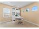 A bright office featuring three windows and a built-in display cabinet with glass doors at 10007 Hazelnut Ct, Tampa, FL 33647