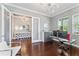 Home office featuring glass desk, contemporary decor, and ample natural light through windows and glass doors at 10007 Hazelnut Ct, Tampa, FL 33647