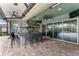 Outdoor kitchen with stainless appliances, bar, decorative tiles, and a covered patio at 10007 Hazelnut Ct, Tampa, FL 33647