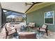 Inviting screened patio with comfortable seating, overlooking the pool, spa, and yard at 10007 Hazelnut Ct, Tampa, FL 33647