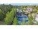 Overhead community playground view with multiple play structures and a large cushioned surface, surrounded by trees at 10007 Hazelnut Ct, Tampa, FL 33647