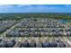 Expansive aerial view of a well-planned residential community with lush greenery and a tranquil lake at 10222 Cool Waterlily Ave, Riverview, FL 33578