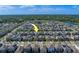 Wide aerial shot of a residential area showcasing uniform housing and beautiful surrounding greenery at 10222 Cool Waterlily Ave, Riverview, FL 33578