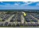 Birds eye view of neighborhood with lush green trees and landscaped yards under a clear blue sky at 10222 Cool Waterlily Ave, Riverview, FL 33578