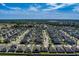 Expansive aerial view of a well-planned residential community with lush greenery and clear blue skies at 10222 Cool Waterlily Ave, Riverview, FL 33578