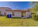 Backyard featuring green grass, an AC unit, and garbage cans at 10222 Cool Waterlily Ave, Riverview, FL 33578