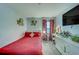 Bedroom featuring a vanity, a red bed, and wall decor at 10222 Cool Waterlily Ave, Riverview, FL 33578