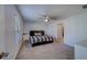 Large, well-lit bedroom with a window, ceiling fan, and neutral colors at 10222 Cool Waterlily Ave, Riverview, FL 33578