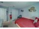 Bright bedroom featuring a bed, closet, and cozy chair at 10222 Cool Waterlily Ave, Riverview, FL 33578