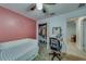 Charming bedroom with pink accent wall, ceiling fan, closet, and neutral carpeting at 10222 Cool Waterlily Ave, Riverview, FL 33578