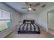 Spacious bedroom with ceiling fan, window, and neutral carpeting at 10222 Cool Waterlily Ave, Riverview, FL 33578