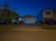 Charming single-Gathering home with well-maintained lawn and festive blue lighting at twilight at 10222 Cool Waterlily Ave, Riverview, FL 33578