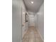 Inviting hallway with neutral paint, decorative mirror, and ceramic tile flooring at 10222 Cool Waterlily Ave, Riverview, FL 33578