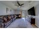 Comfortable living room with ceiling fan, TV, and access to the patio at 10222 Cool Waterlily Ave, Riverview, FL 33578