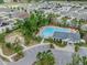 Aerial view of community pool, clubhouse, basketball court, and homes at 10222 Cool Waterlily Ave, Riverview, FL 33578