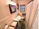 Bathroom with pedestal sink and tiled walls at 103 1St St, Belleair Beach, FL 33786
