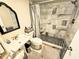 Bathroom featuring marble tile shower, white vanity, and black and white floor at 103 1St St, Belleair Beach, FL 33786