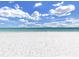 Stunning white sandy beach with clear blue skies and crystal-clear water perfect for relaxation at 103 1St St, Belleair Beach, FL 33786