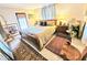 Comfortable bedroom with hardwood floors, soft lighting, and stylish rugs at 103 1St St, Belleair Beach, FL 33786
