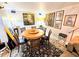 Elegant dining room featuring a round table with six chairs and decorative wall art at 103 1St St, Belleair Beach, FL 33786