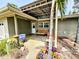 A house exterior with outdoor seating, plants, and a decorative pot at 103 1St St, Belleair Beach, FL 33786