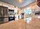 Bright kitchen with stainless steel appliances, white cabinets, and a patterned backsplash at 103 1St St, Belleair Beach, FL 33786