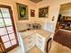 Cozy kitchen nook with custom cabinets, granite counters, and an exit to the backyard at 103 1St St, Belleair Beach, FL 33786