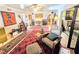 Spacious living area with diverse furnishings, decor, and abundant sunlight and artwork at 103 1St St, Belleair Beach, FL 33786
