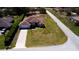 An aerial shot of the home, showcasing its well-manicured lawn, long driveway, and proximity to nearby streets at 10400 Golden Ave, Weeki Wachee, FL 34613