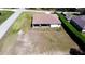 Aerial view of home with a fenced-in backyard and covered patio, perfect for outdoor entertaining and privacy at 10400 Golden Ave, Weeki Wachee, FL 34613