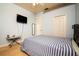 Bedroom with blue walls, two closets and a mounted TV at 10400 Golden Ave, Weeki Wachee, FL 34613