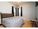 Cozy bedroom features blue walls, carpet, and natural light from the windows at 10400 Golden Ave, Weeki Wachee, FL 34613