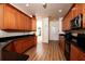 Well-lit kitchen featuring wood cabinets, black countertops and stainless steel appliances at 10400 Golden Ave, Weeki Wachee, FL 34613