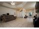 Spacious living room with tiled floors, ceiling fan, and access to the dining area at 10400 Golden Ave, Weeki Wachee, FL 34613