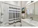 Cozy bathroom showcasing a vanity, toilet, combination tub and shower with a striped shower curtain, for a clean aesthetic at 10608 Gretna Green Dr, Tampa, FL 33626