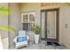 Cozy front porch with seating and a decorative front door offers a warm welcome at 10608 Gretna Green Dr, Tampa, FL 33626