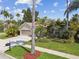 Charming single-story home boasts a three-car garage, mature landscaping, and a well-manicured lawn at 10608 Gretna Green Dr, Tampa, FL 33626