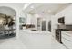 Modern white kitchen with stainless steel appliances, sleek countertops, and ample cabinet space at 10608 Gretna Green Dr, Tampa, FL 33626