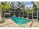 Screened pool with waterfall feature, deck, and surrounding tropical foliage at 10608 Gretna Green Dr, Tampa, FL 33626