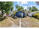 Backyard features a charming blue shed and lovely patio sitting area at 1115 Crescent Lake N Dr, St Petersburg, FL 33701