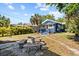 Backyard featuring outdoor seating, a palm tree, and lush green grass at 1115 Crescent Lake N Dr, St Petersburg, FL 33701