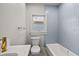 Stylish bathroom featuring blue tiled wall accents over the bathtub and modern gold fixtures at 1115 Crescent Lake N Dr, St Petersburg, FL 33701