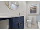 Modern bathroom with navy vanity, gold fixtures, and stylish mirror at 1115 Crescent Lake N Dr, St Petersburg, FL 33701