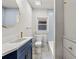 Charming bathroom featuring a blue vanity, stylish mirror, and modern fixtures at 1115 Crescent Lake N Dr, St Petersburg, FL 33701