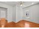 Bright bedroom with hardwood floors, a ceiling fan, and a large window at 1115 Crescent Lake N Dr, St Petersburg, FL 33701