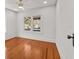 Bright bedroom featuring hardwood floors, a ceiling fan and window views at 1115 Crescent Lake N Dr, St Petersburg, FL 33701