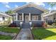 Charming bungalow-style home with a covered front porch and well-manicured landscaping at 1115 Crescent Lake N Dr, St Petersburg, FL 33701