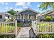 Charming blue home featuring a cozy front porch with a white picket fence at 1115 Crescent Lake N Dr, St Petersburg, FL 33701